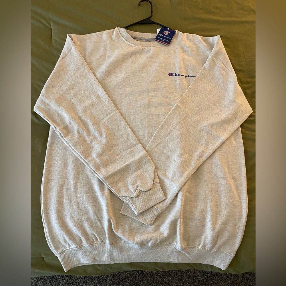 Men’s champion crewneck sweater. Size XLT. Color is a cream/grey. NWT.